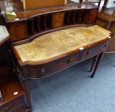 Lot 1052 - A reproduction writing table with leather top and superstructure of pigeon holes and drawers