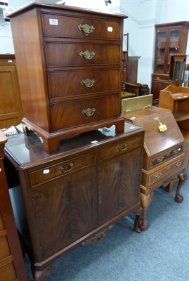Lot 1056 - A small reproduction four height chest of drawers of George III style together with a sideboard...