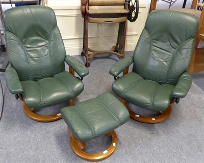 Lot 1068 - A green leather upholstered Stressless reclining chair and footstool and another (3)