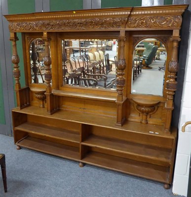 Lot 1070 - A carved oak mirrored upper section of a sideboard, together with a low two tier open bookcase