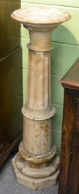 Lot 1146 - An alabaster pedestal with fluted column support, 113cm high
