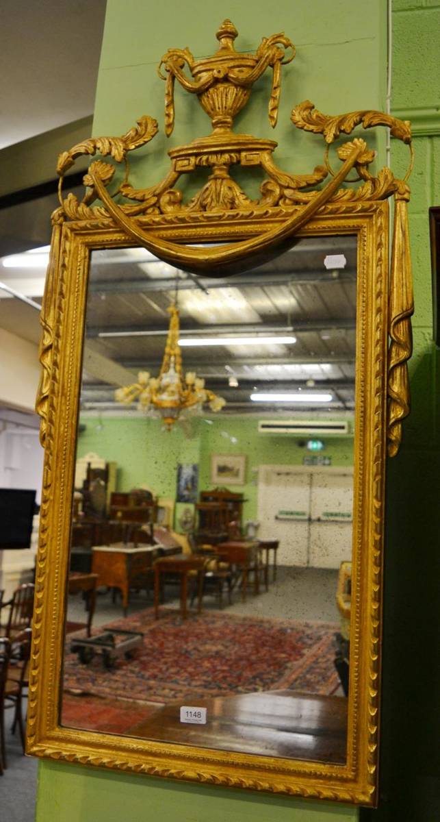 Lot 1148 - A 20th century carved gilt wood mirror, with urn and swag decoration, 120cm by 59cm at maximum