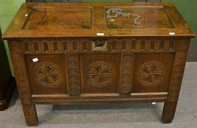 Lot 1150 - An early 18th century joined oak chest, the hinged lid above a fluted frieze and three panels...