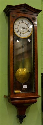 Lot 1161 - A walnut veneered single weight driven Vienna type wall timepiece