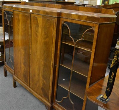 Lot 1173 - A 20th century break front bookcase cabinet, with central pair of doors enclosing a shelved...