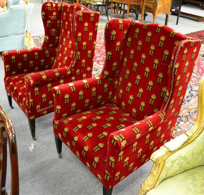 Lot 1190 - A pair of upholstered wingback armchairs, dark red pattern fabric