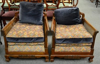 Lot 1199 - A pair of bergere armchairs, with caned back and sides