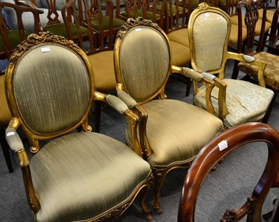 Lot 1206 - A pair of gilt wood open armchairs together with another similar example (3)