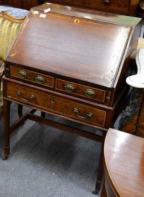 Lot 1224 - A George III mahogany and marquetry inlaid bureau on stand, late 18th century, the fall enclosing a