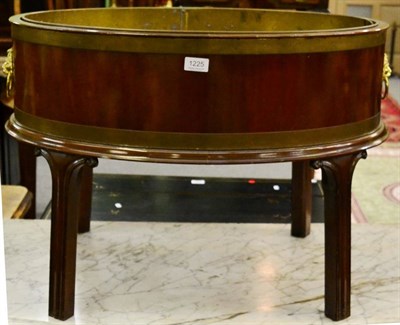 Lot 1225 - A reproduction brass bound mahogany wine cooler on stand