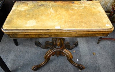 Lot 1228 - A Victorian walnut fold over card table on cabriole supports