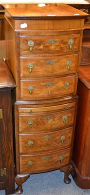 Lot 1252 - A slender reproduction walnut chest of drawers, with brushing slide, on cabriole supports