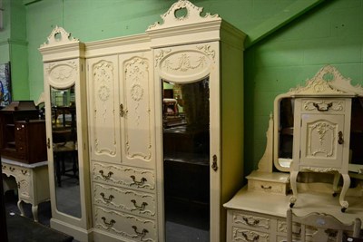 Lot 1264 - A cream painted bedroom suite comprising wardrobe, dressing table and chair, bedside cabinet, a...