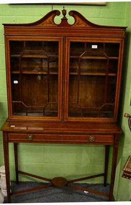 Lot 1267 - An Edwardian Sheraton style mahogany display cabinet, the broken swan-neck pediment with...