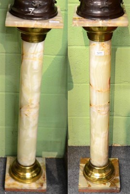 Lot 1271 - A pair of brass mounted onyx columns, 94cm high