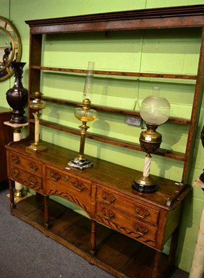 Lot 1272 - An oak pot board dresser and rack with unusual inlaid decoration to the apron, on turned...