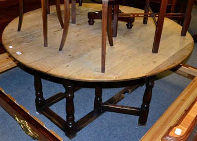 Lot 1285 - A circular oak gate leg table