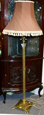 Lot 1290 - A brass standard lamp, late 19th century, modelled as a Corinthian column, the reservoir on...