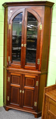 Lot 1292 - A late George III mahogany and boxwood strung free-standing corner cupboard, the upper section with