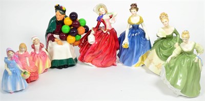 Lot 7 - Eight Royal Doulton figures ";The Old Balloon Seller";, ";Autumn Breezes";, ";Fair Lady";,...