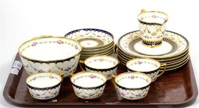 Lot 18 - A Royal Crown Derby part tea service, decorated with floral swags within blue and gilt borders