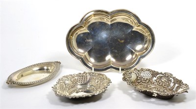 Lot 26 - A shaped oval silver dish, London 1905; two smaller repousse decorated dishes; and another...