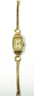 Lot 51 - A lady's 9 carat gold wrist watch, signed Rolex, on a rolled gold bracelet strap