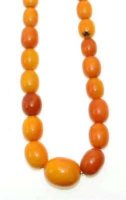 Lot 65 - An amber bead necklace, graduated oval amber beads, to a barrel clasp, length 74cm, beads range...