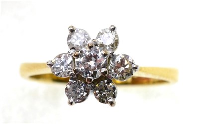 Lot 71 - An 18 carat gold diamond cluster ring, an old cut diamond within a border of six round cut diamonds