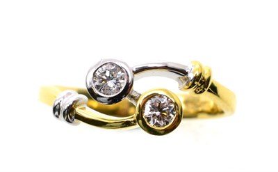 Lot 79 - An 18 carat two colour gold diamond ring, two round brilliant cut diamonds in rubbed over settings
