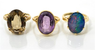 Lot 94 - A 9 carat gold opal triplet ring, an oval cabochon opal triplet in a claw setting, to tapered...