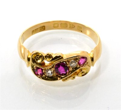 Lot 97 - An 18 carat gold ruby and diamond ring, three graduated oval cut rubies spaced by two old cut...