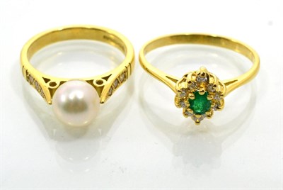 Lot 110 - An emerald and diamond cluster ring, an oval cut emerald within a border round brilliant cut...