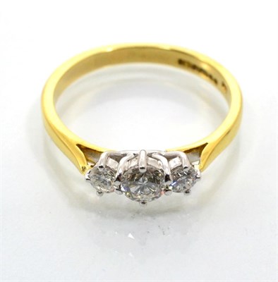 Lot 113 - An 18 carat gold diamond three stone ring, graduated round brilliant cut diamonds in claw...