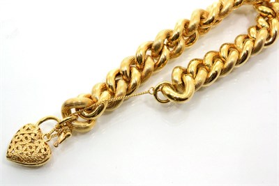 Lot 118 - A 9 carat gold curb and lock bracelet, alternating plain and textured links to a pierced heart...