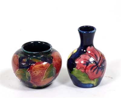Lot 130 - A Walter Moorcroft Hibiscus vase and a William Moorcroft Pomegranate vase (a.f.) (2)