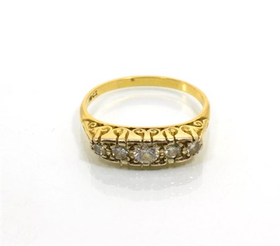 Lot 212 - A diamond five stone ring, graduated round brilliant cut diamonds in a carved scroll setting, total