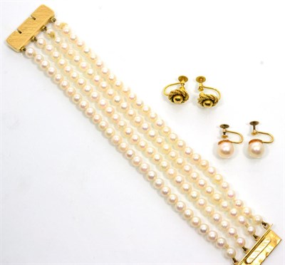 Lot 218 - A cultured pearl bracelet, four strands of uniform cultured pearls knotted to a chased oblong...