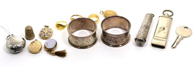 Lot 223 - A silver sovereign holder; an amber cheroot holder in a silver case; two silver napkin rings; a...