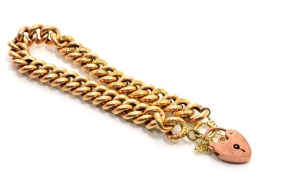 Lot 234 - A curb link bracelet, of alternating chased and plain links, to a 9 carat gold padlock clasp,...