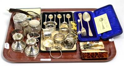 Lot 322 - Assorted silver items including napkin rings; a pair of dwarf candlesticks; cased set of...