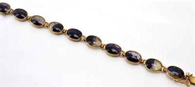 Lot 342 - A 9 carat gold Blue John bracelet, oval cabochons in rubbed over settings, as individual links,...