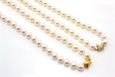 Lot 355 - A cultured Akoya pearl necklace, uniform pearls knotted to a diamond set X-shaped clasp,...