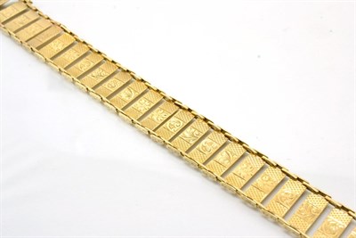 Lot 360 - A bracelet, of engine turned and foliate chased rectangular links, length 18cm, stamped '9CT'