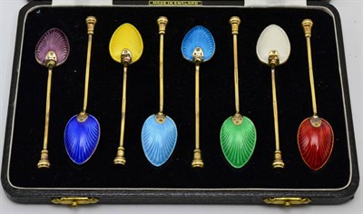 Lot 364 - A set of eight silver gilt and enamel coffee spoons, cased