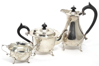 Lot 381 - A matched silver three piece tea set, the teapot and hot water jug Chester 1921/24, the sugar...