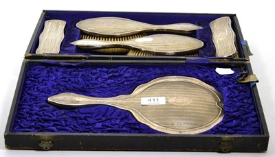 Lot 411 - A six piece silver backed dressing table set (cased)