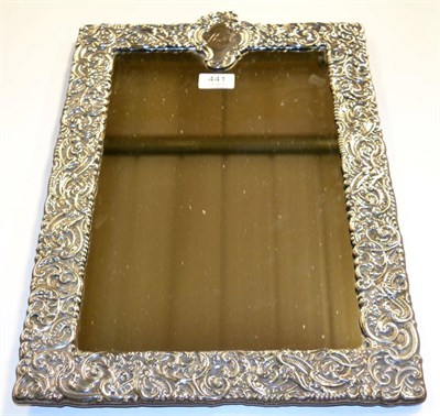 Lot 441 - A late Victorian large silver framed mirror, indistinct marks, repousee scrollwork decoration,...