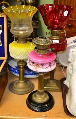 Lot 455 - A Victorian oil lamp, cranberry shade and reservoir; together with another, yellow tinted shade and