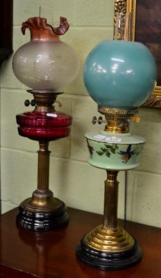 Lot 474 - A Victorian oil lamp with cranberry glass reservoir, together with another Victorian oil lamp...